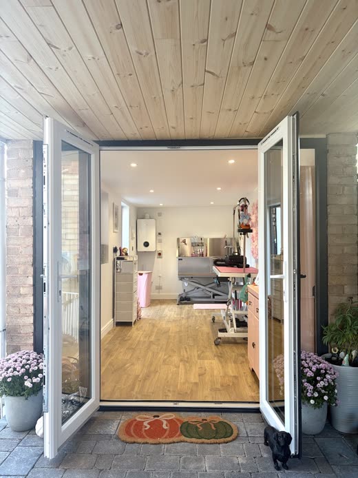 The grooming table and trolley inside the garden-room salon, tight crop